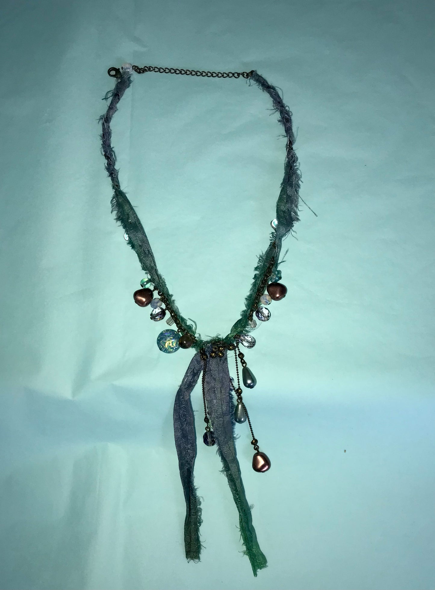 Mermaid recycled necklaces wrapped in sari silk remnants.